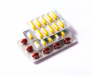 Various cold prescription bottles and a syringe isolated on a wh