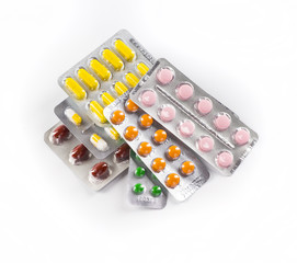 Medications tablets and capsules in a beaker