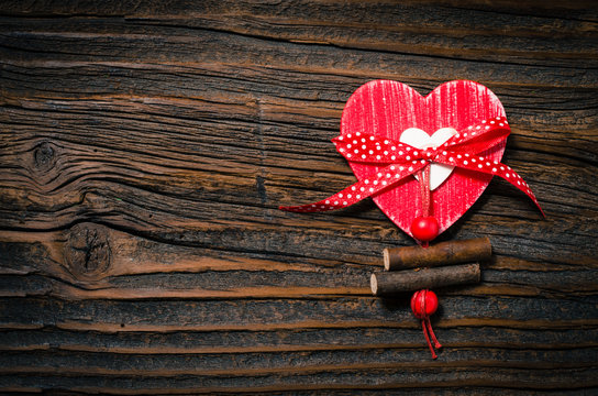 Red heart on an old wooden background