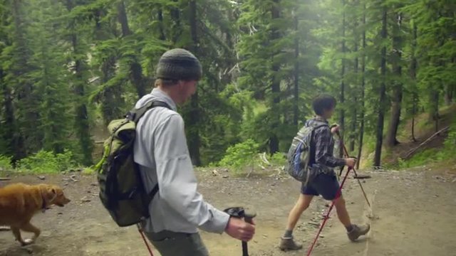 Medium shot of three hikers walking past the camera 