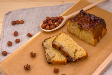 Banana cake homemade with hazelnuts and wooden spoon