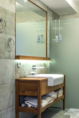 Sink with big mirror and shower cabin 