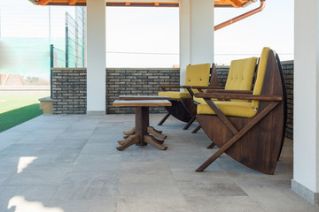 Armchairs on open terrace in luxury villa exterior