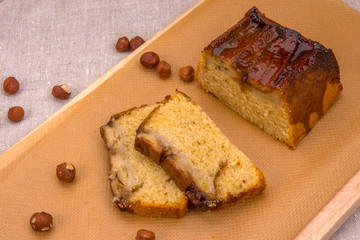 Homemade banana cake with hazelnuts on brown paper