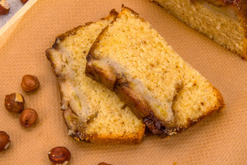Two slices of homemade banana cake with hazelnuts
