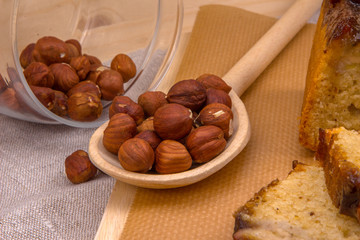 Wooden spoon with hazelnuts and banana cake homemade
