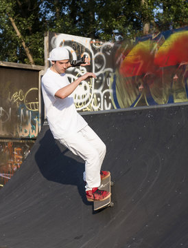 Skateboarder doing a trick at skateboard park