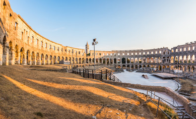 Naklejka premium Inside of Ancient Roman Amphitheater in Pula, Croatia, Famous Travel Destination, in Sunny Summer Evening