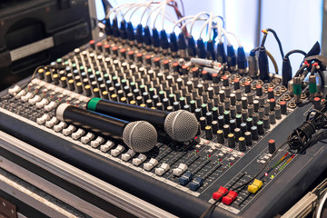 Fototapeta na wymiar Two wireless microphone on sound mixer control panel