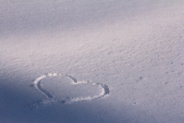 Heart shape drawn in snow