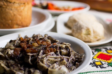 Poppy seed pasta served on a plate with other desserts.