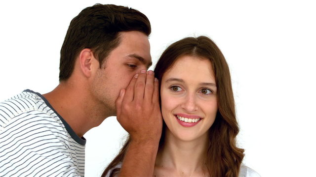 Man telling secret to surprised woman