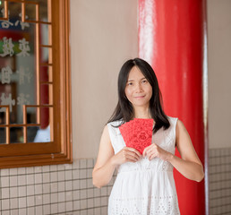 Asian lady holding red envelope or Ang-pow .