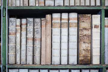 historic old books in library, wooden bookshelf