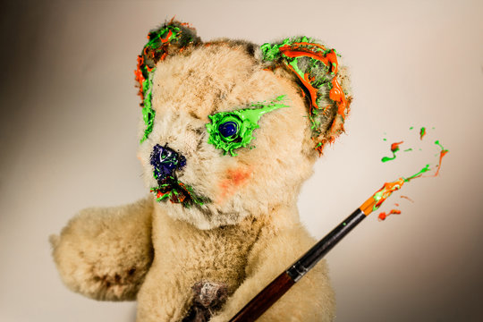 Teddy bear as an artist with paintbrush