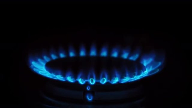 Gas Stove Burner Lighting Close Up Center. a close up shot of a gas burner on a stove being lit. audio included
