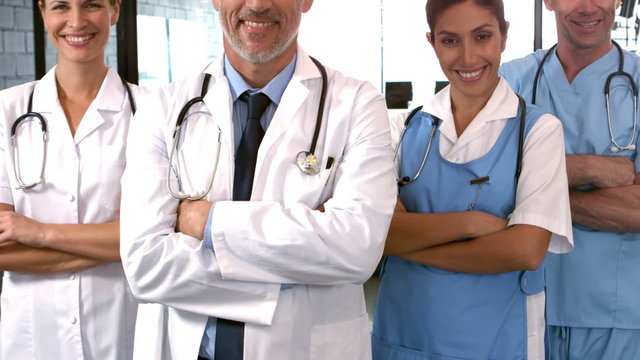 Smiling medical team with arms crossed