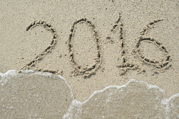 2016 sign on beach sand