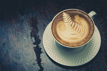 Fototapeta na wymiar Cup of latte Coffee on wood table