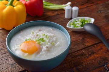 Thai chinese asian rice porridge with pork and egg  in  bowl, co