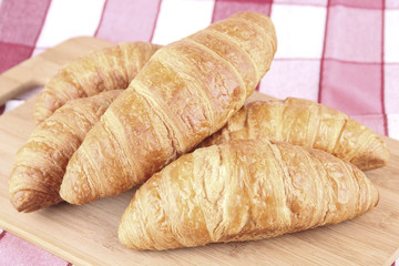 croissant on wooden board, breakfast theme