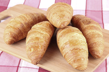 croissant bread on wooden board, breakfast