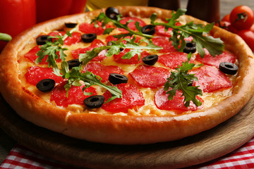 Tasty pizza with salami on decorated wooden table, close up