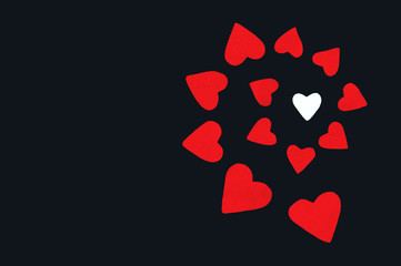 red paper hearts on the black background