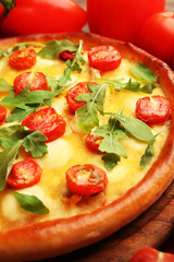 Pizza Margherita with arugula and vegetables, close-up