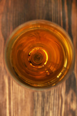 Glass of wine on wooden table. Top view