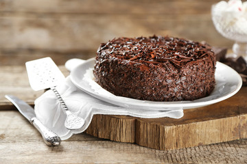Tasty chocolate cake on wooden background