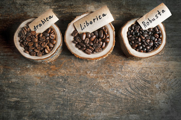 Collection of coffee beans on old wooden table, close up