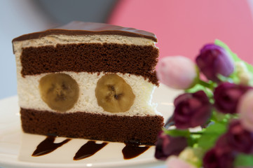 Piece of banana chocolate cake in white plate