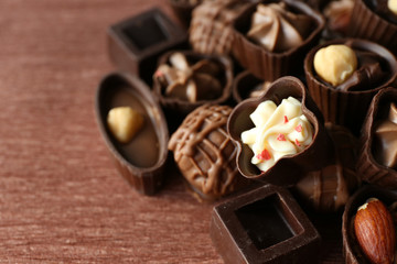 Appetizer chocolate candies on wooden background