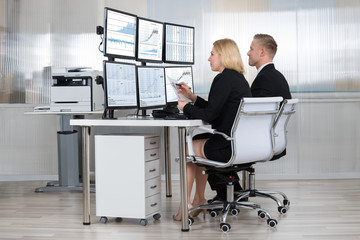 Financial Workers Analyzing Data In Office