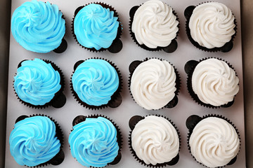 Tasty cupcakes in paper box, close up
