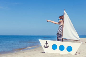 little boy standing on the beach
