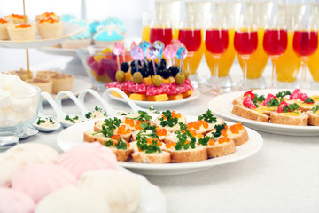 Set of cold snacks, canape, beverages, closeup
