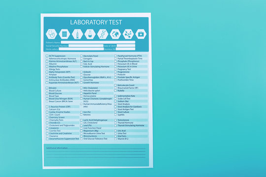 Laboratory test list on blue background, close up