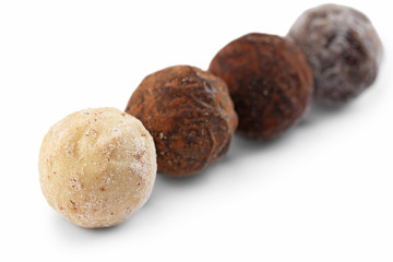 Row of chocolate truffles, isolated on white