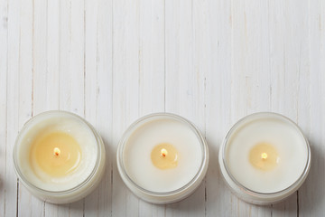 scented candles on white wooden background