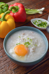 Thai chinese asian rice porridge with pork and egg  in  bowl, co