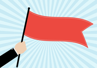 Businessman hold a red flag on bright blue sunrays background. 