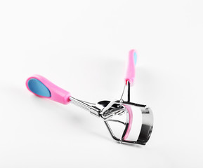 Eyelash curler with pink handle, isolated on white