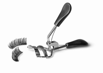 Curler and false eyelashes, isolated on white