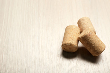 Three wine corks on light wooden background, close up