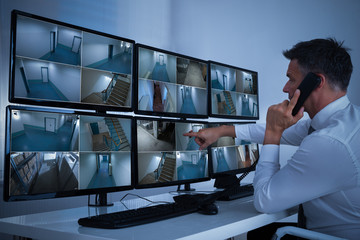 Obraz na płótnie Canvas Security System Operator Looking At CCTV Footage