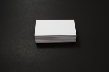 blank business cards stack up on Black background