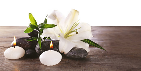 Spa still life with beautiful flower and candlelight on wooden table, closeup