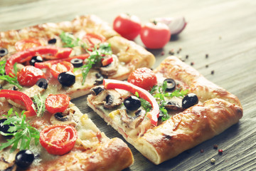 Freshly homemade pizza on wooden table closeup